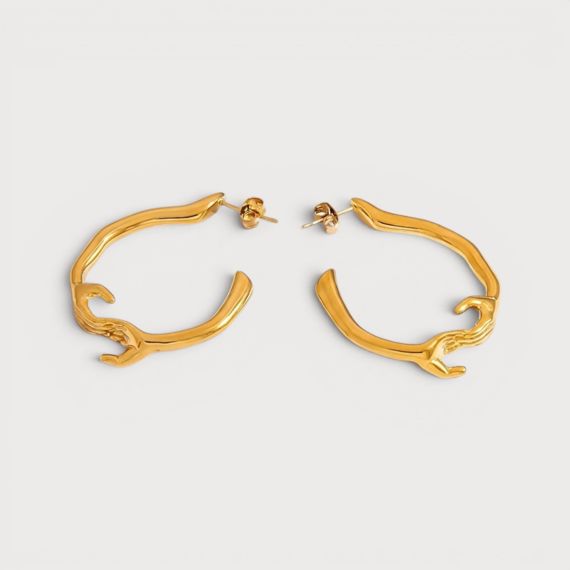 Boucles d’oreilles créoles à motif mains en acier inoxydable doré