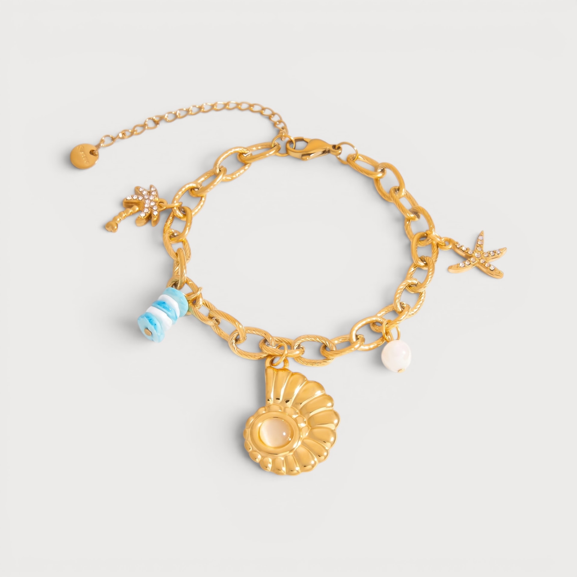 Bracelet palmier, étoile de mer et coquillage en acier inoxydable doré