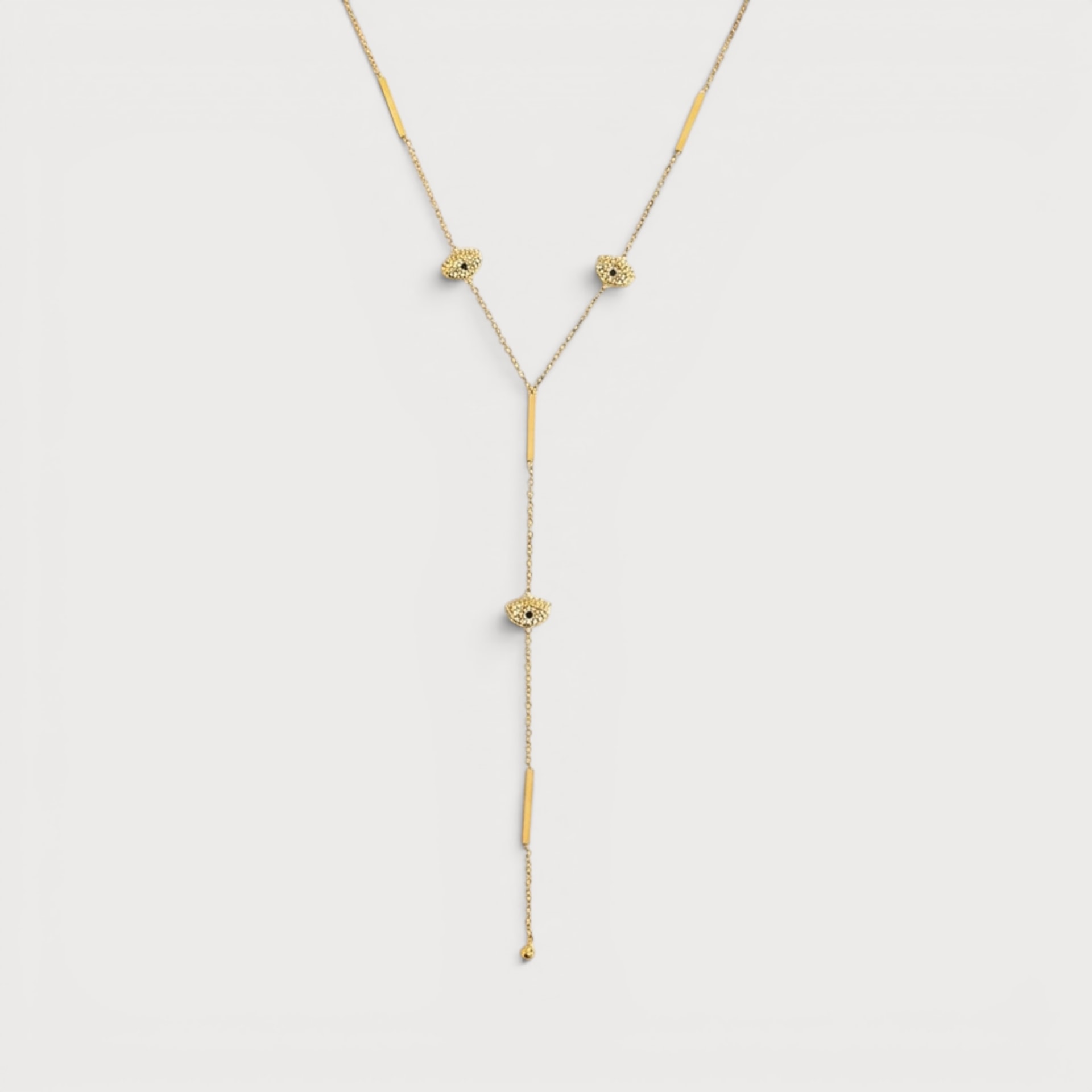 Collier Henriette doré en Y, chaîne fine ponctuée de petits motifs œil